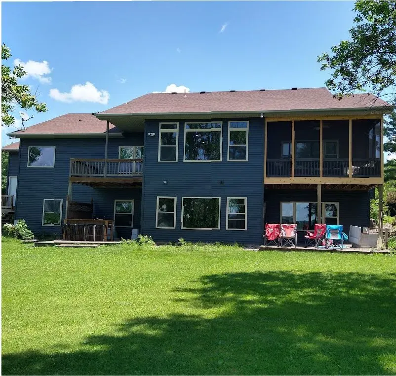 Completed full siding replacement with dark horizontal siding on a two-story home