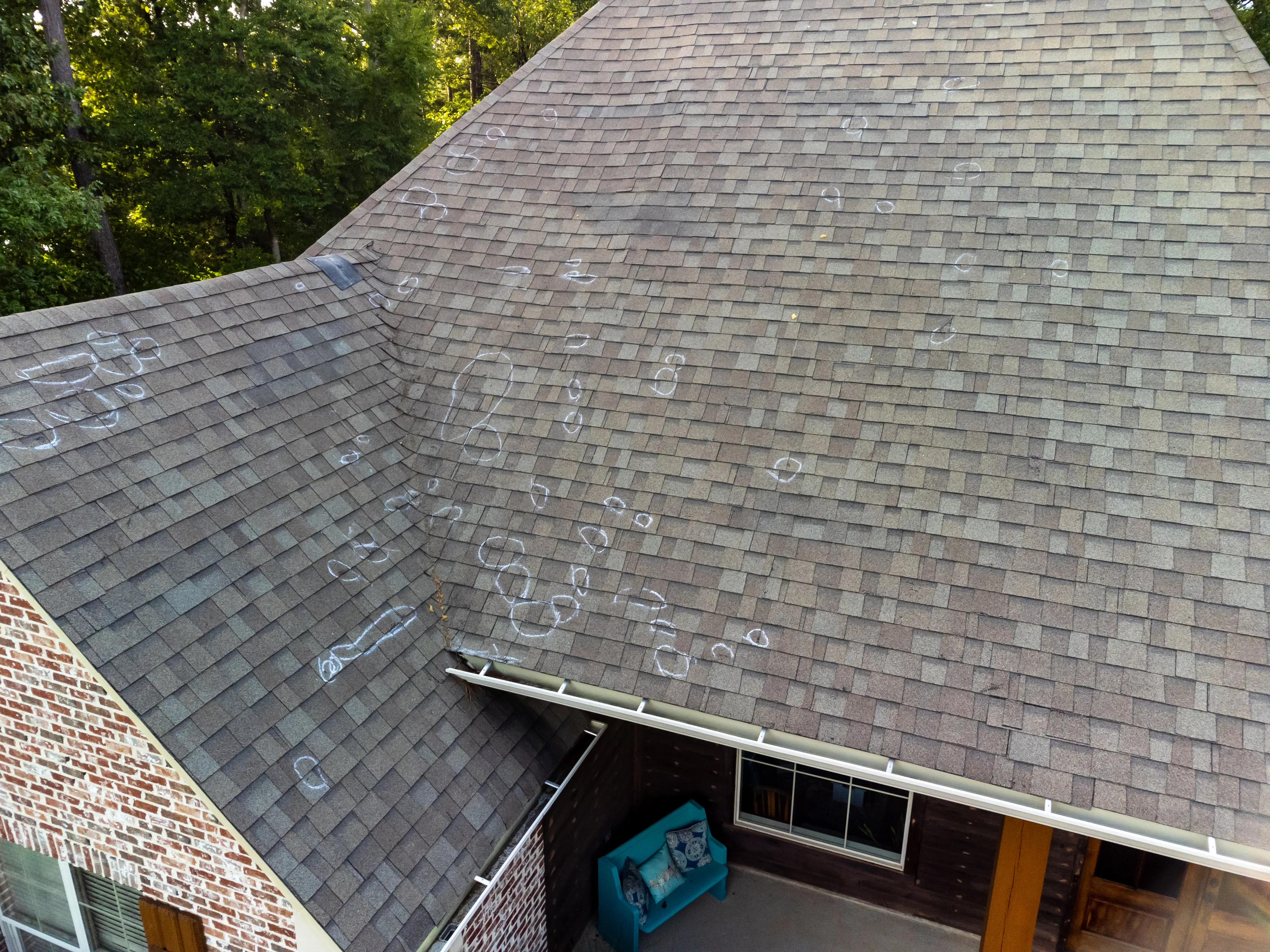 Asphalt shingle roof showing signs of storm damage
